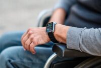 A person in a wheelchair using a Huawei smartwatch. The smartwatch display shows data related to wheelchair activity.