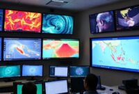 A control room with multiple screens displaying real-time data from seismic sensors, weather patterns, and a map of Sumatra, with emergency response personnel monitoring the system.