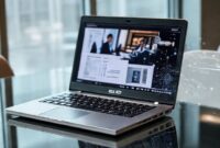 An elegant, professional-looking ASUS ExpertBook PM3 laptop on a modern office desk, with subtle AI-related graphics (neural networks, data streams) overlaid. The screen displays a business meeting or data analysis.